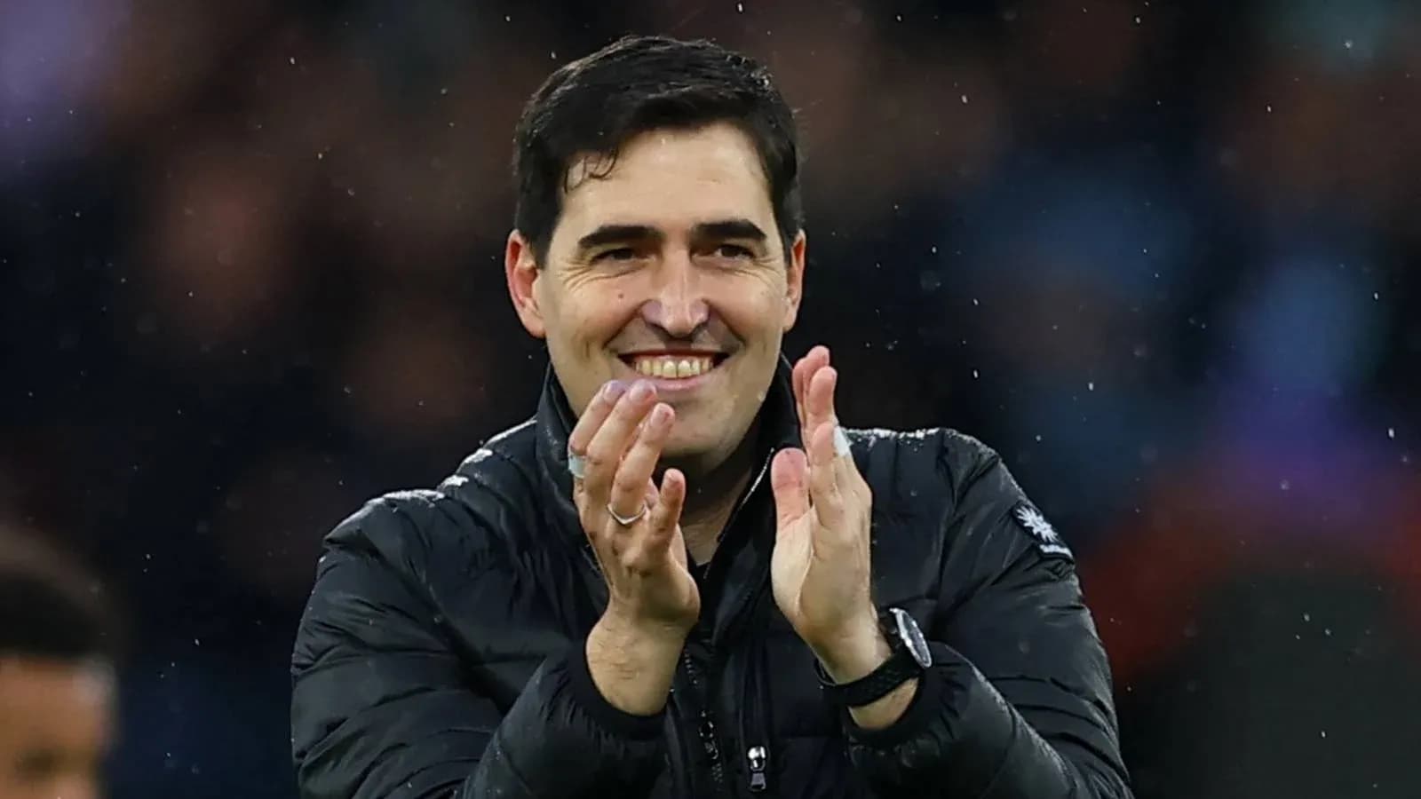 Entrenador aplaudiendo en el banquillo del partido