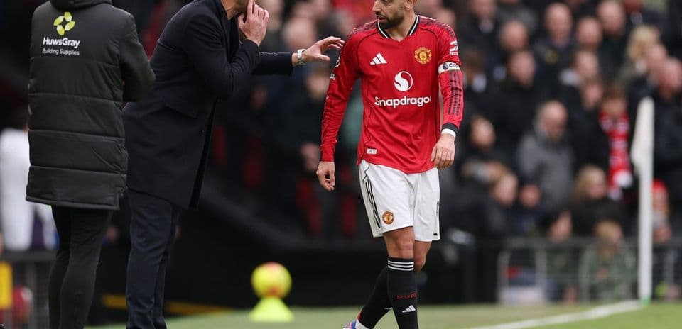 Entrenador dando instrucciones a jugador en el campo