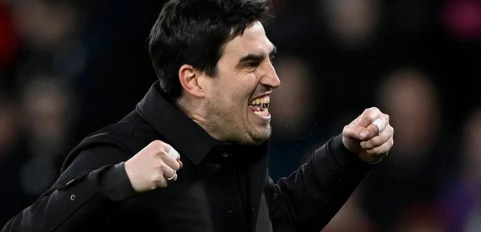 Entrenador celebrando con los puños en alto