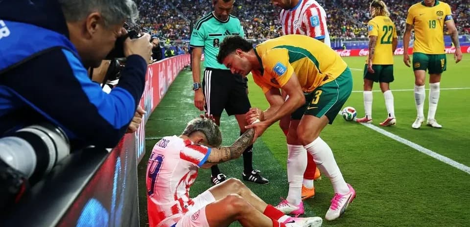 Jugador herido siendo asistido por oponente y árbitro