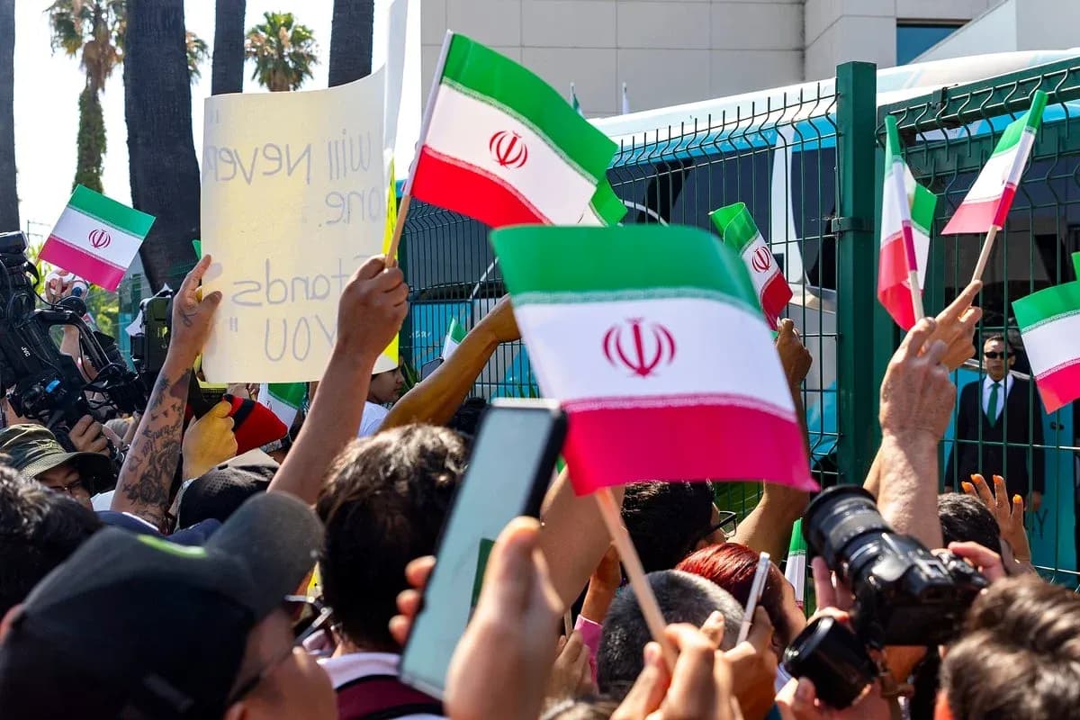 Multitud sosteniendo banderas de Irán en protesta
