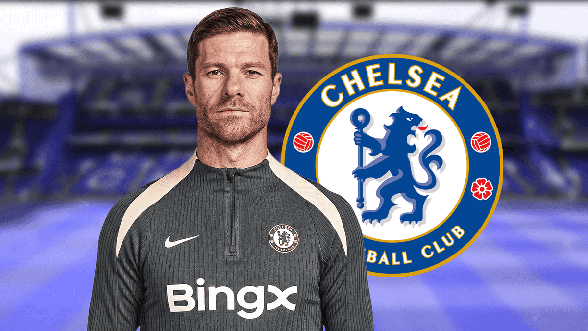 Entrenador posando frente al logo del Chelsea FC Entrenador posando frente al logo del Chelsea FC