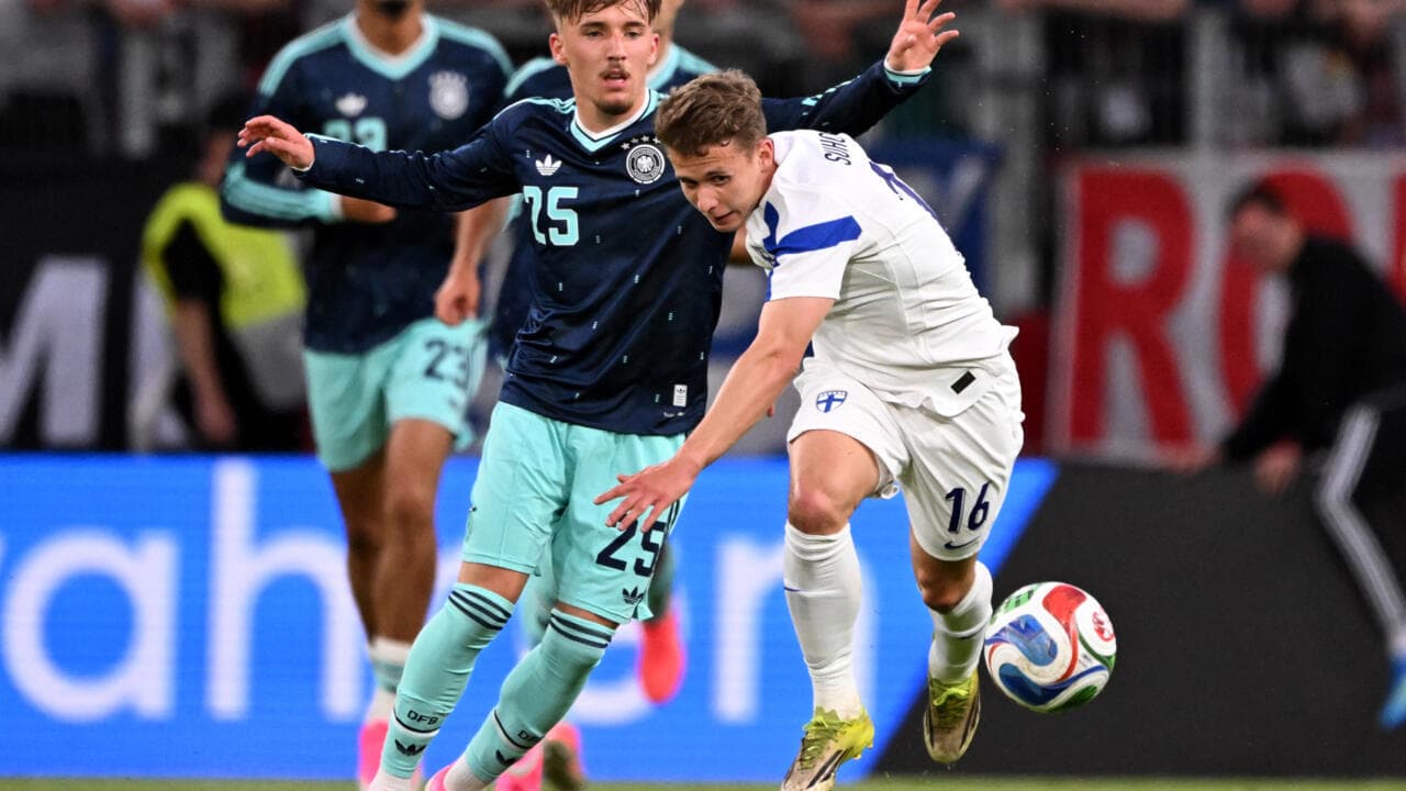 Jugador de Finlandia despojando balón a rival alemán Jugador de Finlandia despojando balón a rival alemán